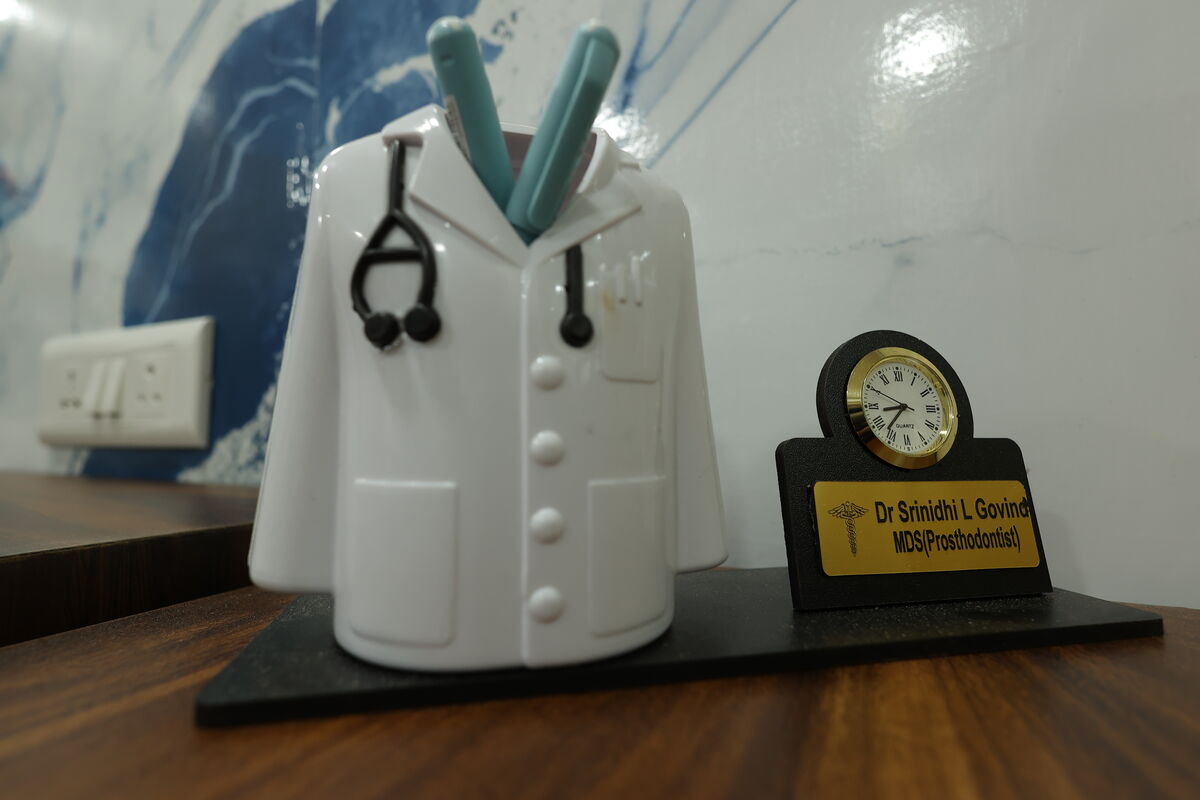 Desk detail with Dr. Srinidhi L. Govind nameplate